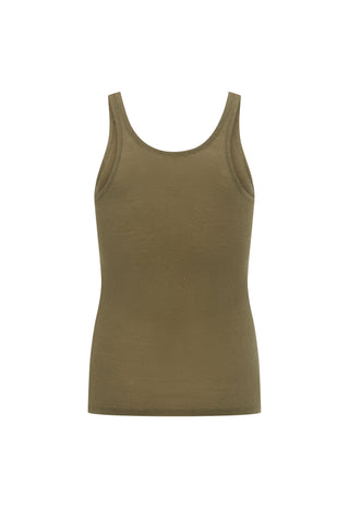 A woman wearing a vintage-style olive green tank top with 'SPELL 1976' printed on the front