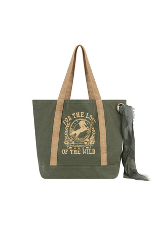 an-olive-green-canvas-tote-bag-with-tan-shoulder-straps-and-a-matching-olive-green-scarf-featuring-a-tan-graphic-print-on-the-front-with-the-text-for-the-love-of-the-wild
