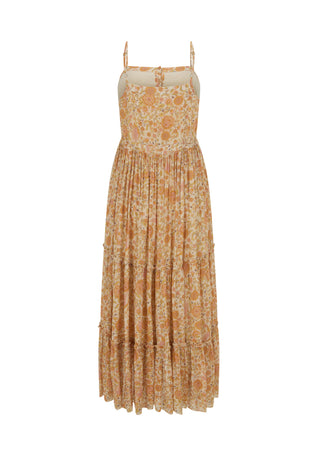  and cream tones. The dress has thin straps and a fringed hem
